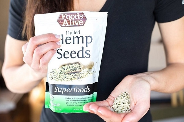 Hulled_Hemp_Seeds_-_Woman_holding_bag_and_pile_of_hemp_seeds_in_hands.jpg