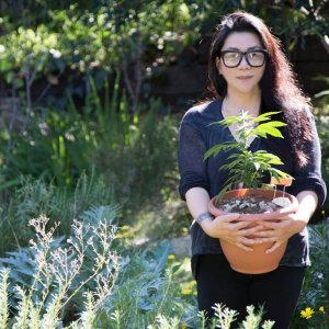 asian girl holding plant