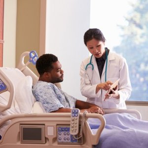 Doctor and Patient in Hospital - Getty Images