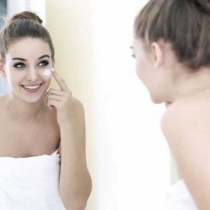 Woman Applying Makeup - Shutterstock