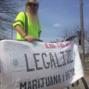 Stephen DeWeese, 65, a Saginaw Township resident, holds a homemade sign