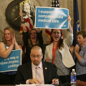 Supporters cheer after the state Senate health committee passed a bill