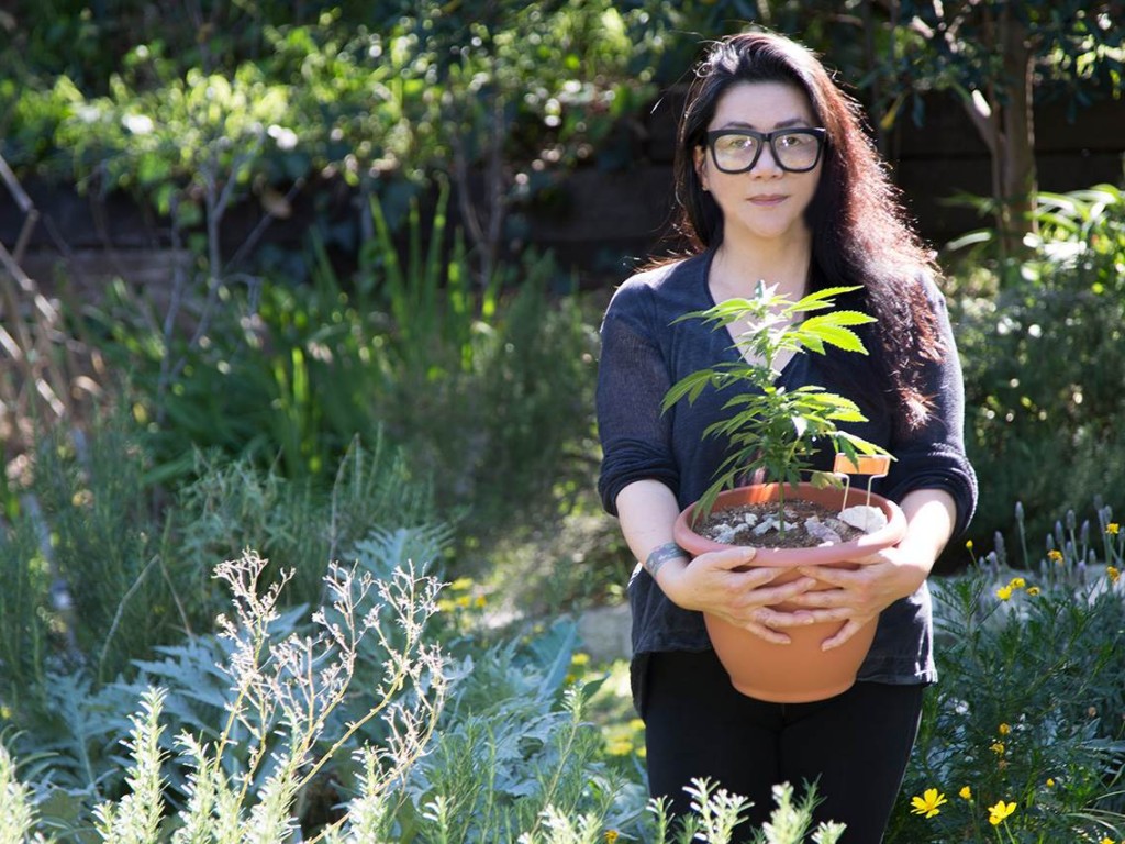 asian girl holding plant