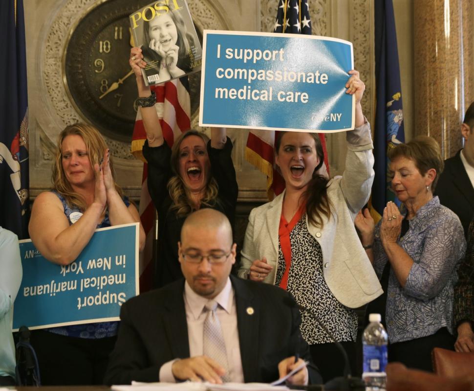 Supporters cheer after the state Senate health committee passed a bill