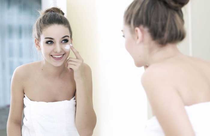 Woman Applying Makeup - Shutterstock