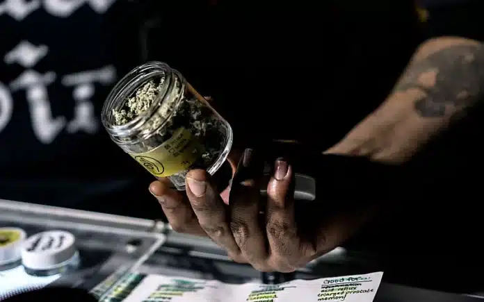 Budtender with jar of cannabis NJ Cannabis Regulatory Commission